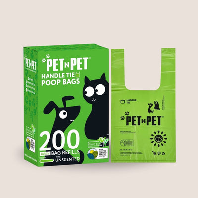 Green box of PET N PET handle tie poop bags with a green bag on a beige background