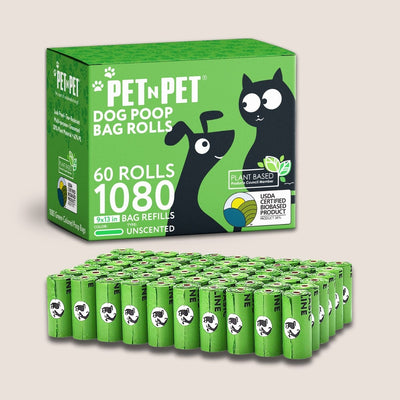 Box of Pet N Pet dog poop bag rolls with multiple bags stacked below on a light gray background